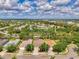 Aerial view of neighborhood homes, with a view of a nearby lake and recreational amenities at 6310 Golden Eye Gln, Lakewood Ranch, FL 34202
