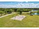Outdoor basketball court in a community park with walking trails and scenic views of a lake at 6310 Golden Eye Gln, Lakewood Ranch, FL 34202