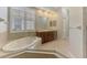 Bathroom boasts soaking tub, large mirror, and double vanity for ample counter space at 6310 Golden Eye Gln, Lakewood Ranch, FL 34202