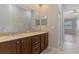 Bathroom with double sinks, granite countertop, and neutral tile flooring at 6310 Golden Eye Gln, Lakewood Ranch, FL 34202