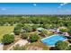 Aerial view of the community park featuring a playground, pond, hockey rink, and recreational space at 6310 Golden Eye Gln, Lakewood Ranch, FL 34202
