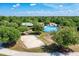Aerial view of community park featuring a playground, sand volleyball court, and hockey rink at 6310 Golden Eye Gln, Lakewood Ranch, FL 34202