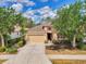 Charming one-story home featuring a well-maintained lawn, mature trees, and a two-car garage at 6310 Golden Eye Gln, Lakewood Ranch, FL 34202