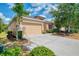 Well-maintained home with a spacious driveway, beautiful trees, and manicured landscaping at 6310 Golden Eye Gln, Lakewood Ranch, FL 34202