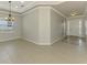 Bright foyer featuring neutral walls, tile floors, chandelier and a white front door with sidelights at 6310 Golden Eye Gln, Lakewood Ranch, FL 34202