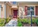 Close-up of front entry with a beautiful door, stone accents, and manicured plants at 6310 Golden Eye Gln, Lakewood Ranch, FL 34202