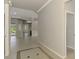 Open hallway leading to various rooms, featuring neutral paint and tile flooring at 6310 Golden Eye Gln, Lakewood Ranch, FL 34202