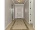 Bright hallway with decorative tile floor and a view of the front door at 6310 Golden Eye Gln, Lakewood Ranch, FL 34202