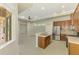 Open-concept kitchen with stainless steel appliances, wood cabinets and adjacent living area at 6310 Golden Eye Gln, Lakewood Ranch, FL 34202