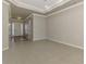 Spacious living room with tile floors and neutral walls, adjacent to the home's entryway at 6310 Golden Eye Gln, Lakewood Ranch, FL 34202