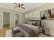 Comfortable main bedroom with wood floors, natural light, and ensuite bathroom entrance at 6310 Golden Eye Gln, Lakewood Ranch, FL 34202