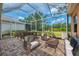 Inviting screened-in patio furnished with dining and seating areas with peaceful backyard views at 6310 Golden Eye Gln, Lakewood Ranch, FL 34202