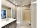 Comfortable bathroom with shower over tub, hard floors, and single sink vanity at 6370 Watercrest Way # 402, Lakewood Ranch, FL 34202