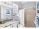 Bathroom featuring a walk-in shower, marble countertop sink, and large mirror at 6510 Flycatcher Ln, Lakewood Ranch, FL 34202