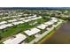 Scenic aerial view of a charming residential community and a serene lake with lush landscaping at 6813 7Th W Ave, Bradenton, FL 34209