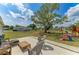Spacious backyard featuring a playset, slide, and an outdoor seating area at 7002 Primm Pl, North Port, FL 34287