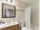 Bathroom featuring a vanity, toilet, and shower with a white shower curtain at 7002 Primm Pl, North Port, FL 34287