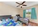 Bedroom featuring two beds, hardwood floors, and a window overlooking the outside at 7002 Primm Pl, North Port, FL 34287