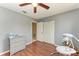 Bedroom featuring hardwood floors, a closet, a dresser, and an adjacent bathroom at 7002 Primm Pl, North Port, FL 34287
