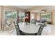 Open dining area with a rustic table set, bright natural light, and seating at 7002 Primm Pl, North Port, FL 34287