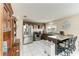 Well-lit kitchen features stainless steel appliances, a breakfast bar with barstool seating, and tile floors at 7002 Primm Pl, North Port, FL 34287