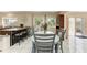 Bright kitchen featuring a dining area, stainless steel appliances, and a sliding glass door to the backyard at 7002 Primm Pl, North Port, FL 34287