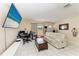 Bright and open living space, complete with a comfortable sofa, a work space, and large windows at 7002 Primm Pl, North Port, FL 34287