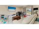 Comfortable living area with tile floors, a large TV, and lots of natural light at 7002 Primm Pl, North Port, FL 34287