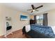 A modern bedroom with a large bed, TV, mirror and ample natural light from a window at 7002 Primm Pl, North Port, FL 34287