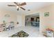 Bright and airy playroom featuring neutral paint colors, toys, a ceiling fan, and a tile floor at 7002 Primm Pl, North Port, FL 34287
