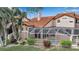 Well-manicured backyard with screened-in lanai and tile roof at 7309 Regina Royale Blvd # 21, Sarasota, FL 34238