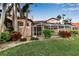 Well-maintained backyard with a screened-in patio and hot tub; lush landscaping and green grass at 7309 Regina Royale Blvd # 21, Sarasota, FL 34238