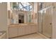 Bright bathroom features a double vanity and a large mirror with stylish lighting at 7309 Regina Royale Blvd # 21, Sarasota, FL 34238