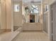 Large bathroom offers a double vanity, a bathtub under a bright window, and a glass enclosed shower at 7309 Regina Royale Blvd # 21, Sarasota, FL 34238