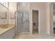 Bathroom with tiled walk-in shower and doorway to the toilet room at 7309 Regina Royale Blvd # 21, Sarasota, FL 34238