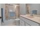Bathroom features a shower-tub combo with sliding glass doors, vanity with drawers and a neutral color palette at 7309 Regina Royale Blvd # 21, Sarasota, FL 34238