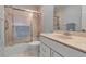 Bathroom features a shower-tub combo with sliding glass doors, vanity with drawers and a neutral color palette at 7309 Regina Royale Blvd # 21, Sarasota, FL 34238