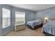 Cozy bedroom featuring carpet floors and two wicker twin beds at 7309 Regina Royale Blvd # 21, Sarasota, FL 34238