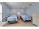 Carpeted bedroom featuring two wicker twin beds and a wicker dresser at 7309 Regina Royale Blvd # 21, Sarasota, FL 34238