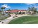 Aerial view of Tournament Players Club featuring terraces, surrounding landscaping and putting green at 7309 Regina Royale Blvd # 21, Sarasota, FL 34238