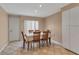 A naturally lit dining area featuring tile floors, a table set for six, and a view of the exterior at 7309 Regina Royale Blvd # 21, Sarasota, FL 34238