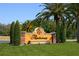 Restanola community sign featuring decorative landscaping and lush trees at 7309 Regina Royale Blvd # 21, Sarasota, FL 34238