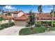 Charming home featuring a terracotta-tiled roof, lush landscaping, and a two-car garage at 7309 Regina Royale Blvd # 21, Sarasota, FL 34238