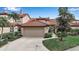 Charming home with terracotta-tiled roof, a two-car garage, and meticulously maintained landscaping at 7309 Regina Royale Blvd # 21, Sarasota, FL 34238