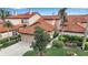 Charming home featuring a terracotta-tiled roof, lush landscaping, and a two-car garage at 7309 Regina Royale Blvd # 21, Sarasota, FL 34238