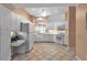 Well-lit kitchen features white cabinets and appliances, ample counter space, and tiled flooring, creating a clean look at 7309 Regina Royale Blvd # 21, Sarasota, FL 34238