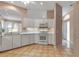 Bright kitchen featuring an open sink area, white cabinetry, and stainless steel appliances at 7309 Regina Royale Blvd # 21, Sarasota, FL 34238