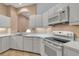 Functional kitchen with white appliances, ample counter space, and tile flooring for easy maintenance at 7309 Regina Royale Blvd # 21, Sarasota, FL 34238