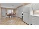 Open-concept kitchen-dining area with tile floors and white cabinets at 7309 Regina Royale Blvd # 21, Sarasota, FL 34238
