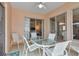 Patio table and chairs on the lanai with views into the living room and bedroom at 7309 Regina Royale Blvd # 21, Sarasota, FL 34238